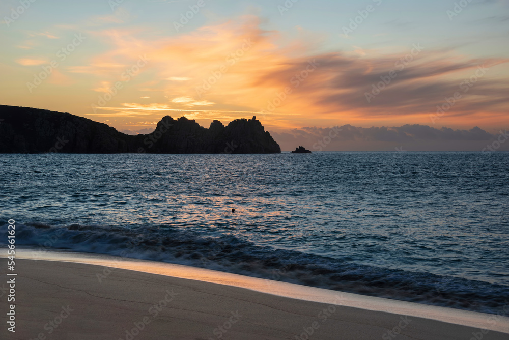 Majestic sunrise landscape at Porthcurno beach in Cornwall England with stunning colours and atmosphere