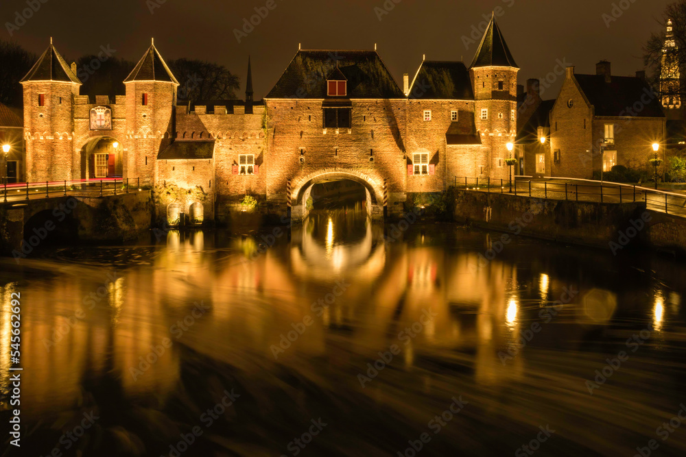 Illuminated medieval gateway Koppelpoort at night, Amersfoort the Netherlands