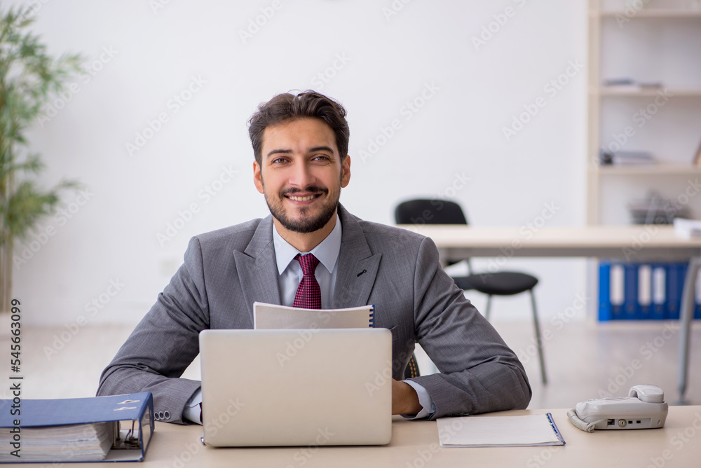 Young male employee working in the office Young male employee working in the office