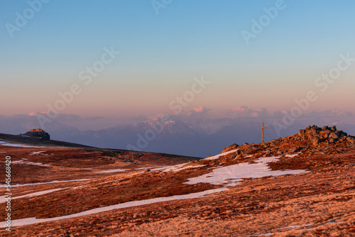 Scenic morning view after sunrise on summit cross of mountain peaks Grosser Sauofen and Zingerle Kreuz, Saualpe, Lavanttal Alps, Carinthia, Austria, Europe. Hiking trail Wolfsberg. Karawanks mountains