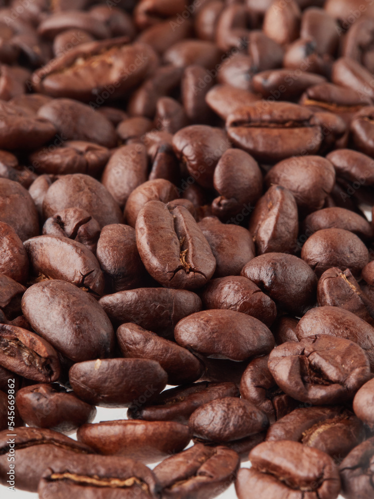 roasted coffee beans macro on a white background with free space roasted coffee beans macro on a white background with free space