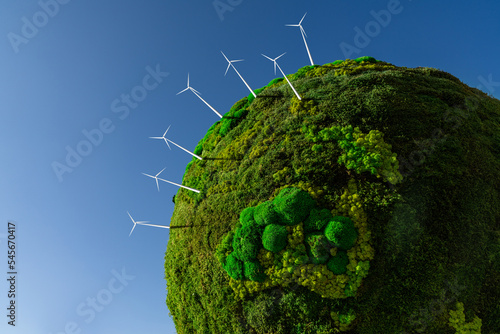 Fototapeta Naklejka Na Ścianę i Meble -  Model of the green planet Earth from moss with wind turbines. Symbol of sustainable development and renewable energy