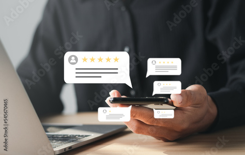 Businessman rates five-star customer service with a virtual screen on a laptop. Satisfaction Survey Concept Reviews Customer Quality Assessment.