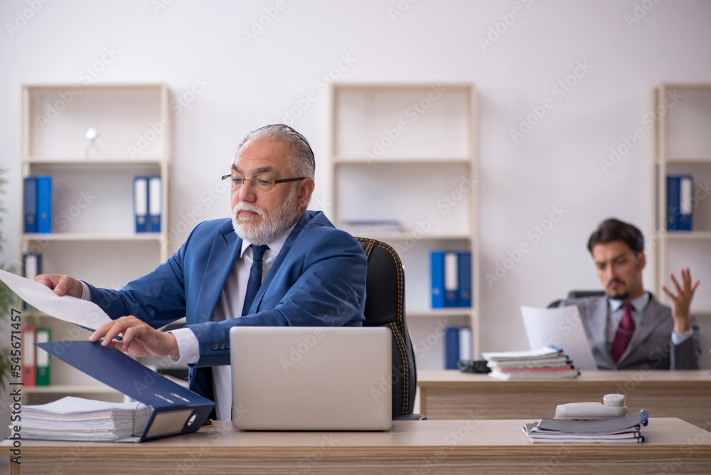 Two male colleagues working in the office Two male colleagues working in the office