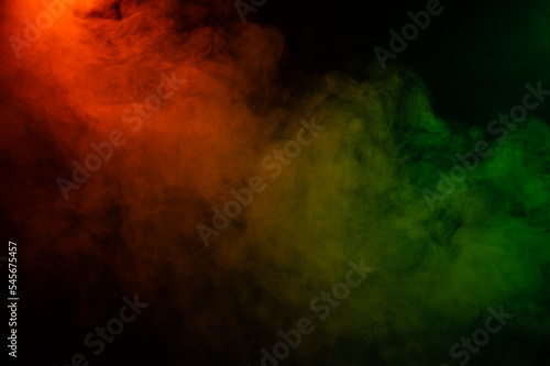 Red yellow green smoke on a black background.