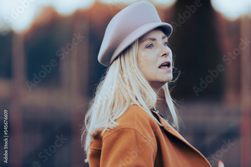Authentic candid portrait of middle-aged pretty woman in stylish autum hat outdoor