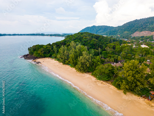 Aerial drone view of Koh Lanta island - the long beach. Famous tropical beach with white sand and turquoise ocean. The island mountains in background. photo