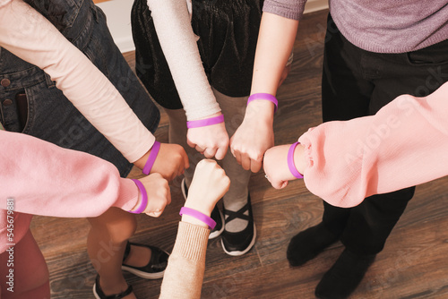hands of girls with same bracelets  team building  cooperation  support and teamwork. Unity and togetherness concept.