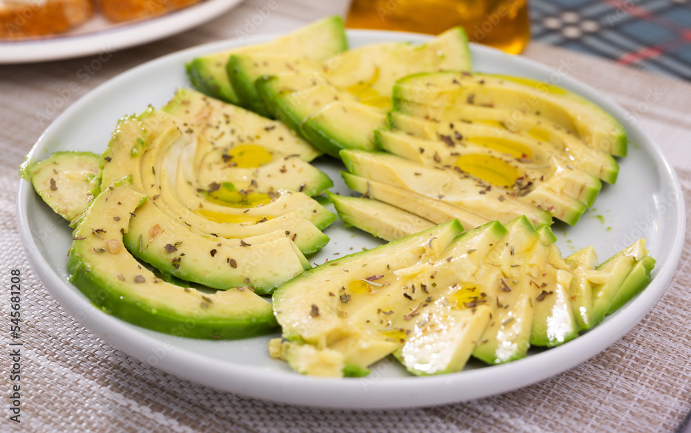 ripe avocado pulp cut into pieces sprinkled with lemon juice on a plate ripe avocado pulp cut into pieces sprinkled with lemon juice on a plate