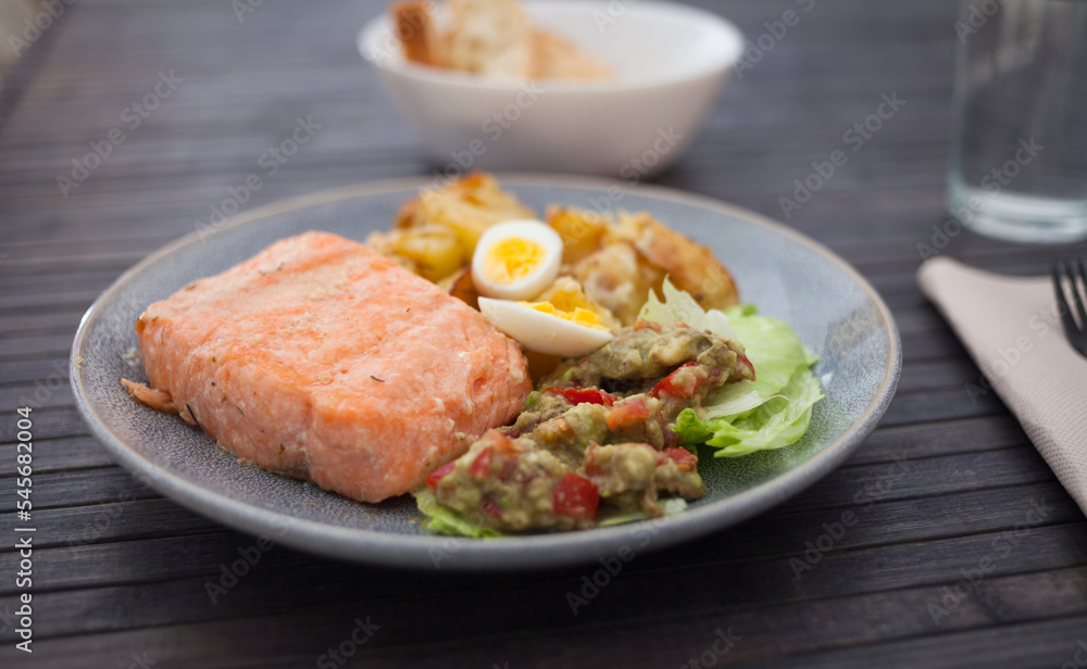 steamed salmon fillet with potato wedges, guacamole homemade and quail egg steamed salmon fillet with potato wedges, guacamole homemade and quail egg