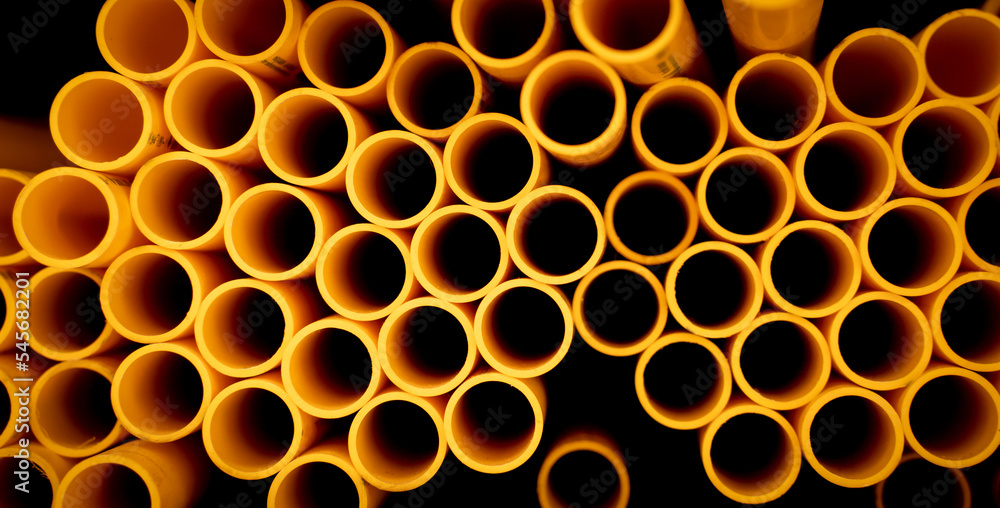 Background of the orange plastic pipes in stacked Background of the orange plastic pipes in stacked