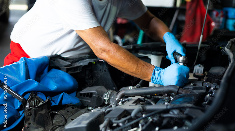 senior asian male mechanic engineering working on Vehicle in Car Service. Repair specialist, technical maintenance. Small business owner. senior asian male mechanic engineering working on Vehicle in Car Service. Repair specialist, technical maintenance. Small business owner.