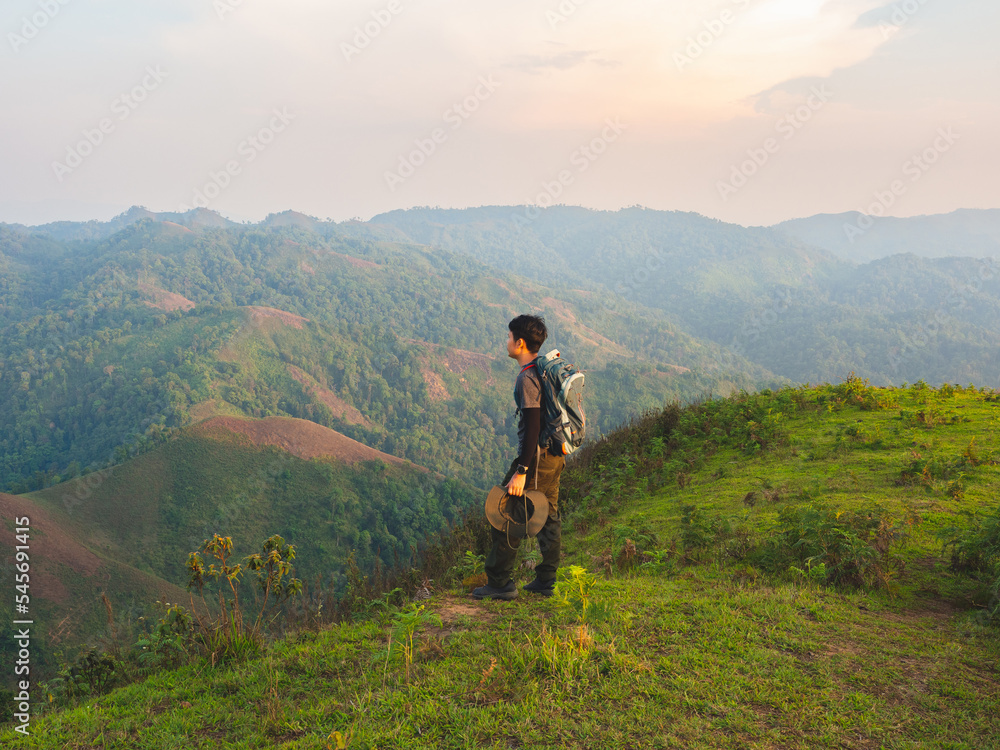 Fototapeta premium Men backpacker are happy and enjoy with sunrise after successful hiking.