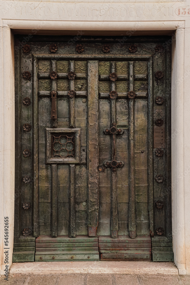 Old Italian green doors made of wood and metal