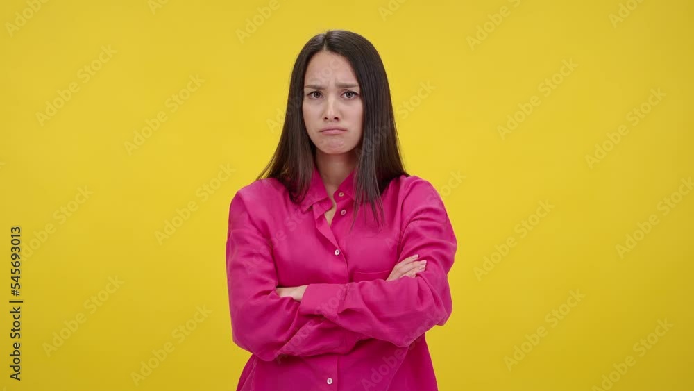 Upset woman crosses arms over chest looking offended Upset woman crosses arms over chest looking offended