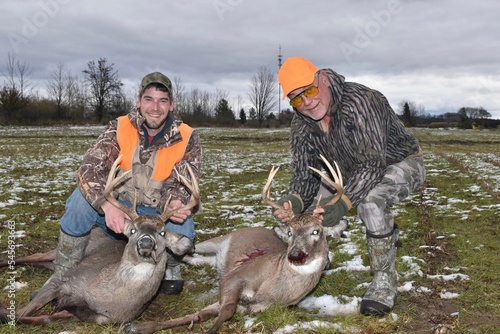 Fototapet A pair of hunters with two trophy bucks