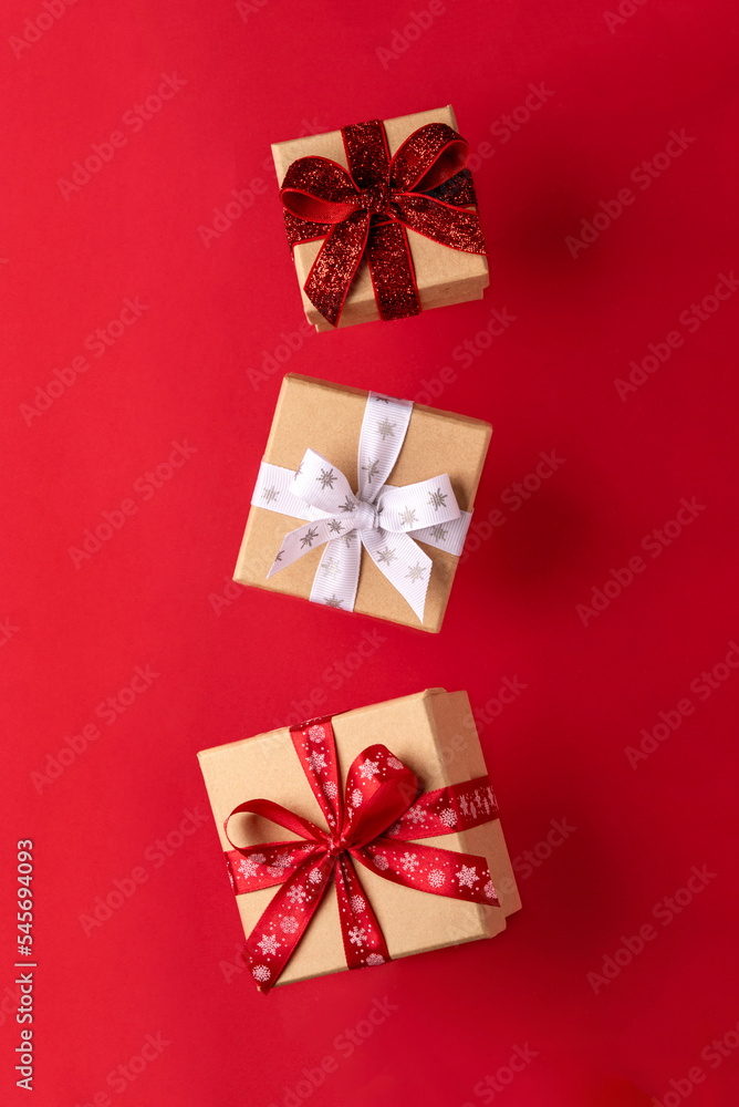 Flying Christmas gift boxes on red background. Flying Christmas gift boxes on red background.