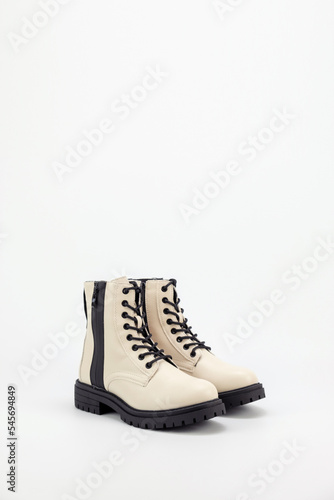 Women white boots pair side aligned on a white background.
