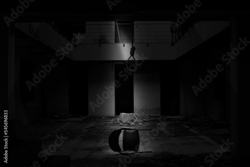 Monochrome shot of a building with a chair on the floor and a loop of rope, a concept of the suicide