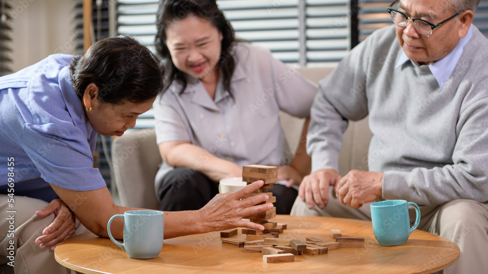 Group of elderly people enjoy talking , relaxing with game at  senior healthcare center.