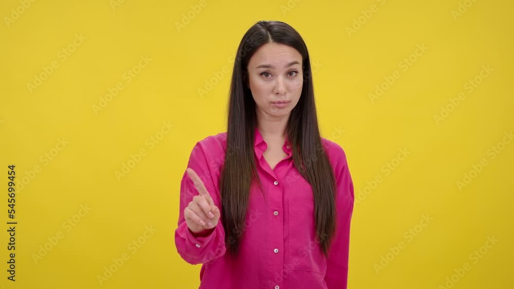 Serious-looking woman shakes index fingers forbiddingly Serious-looking woman shakes index fingers forbiddingly