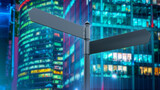 Direction sign in Down Town. Road sign at crossroads. Street sign near skyscraper. Concept of choosing direction in business. Choosing path for business development. Business crossroads. 3d rendering.
