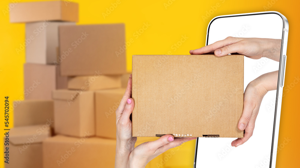 Process of delivering goods. Box in hand. Box in screen of mobile phone. Concept ordering delivery through application. Mobile application courier company. Hands with box in smartphone. Art blurred Process of delivering goods. Box in hand. Box in screen of mobile phone. Concept ordering delivery through application. Mobile application courier company. Hands with box in smartphone. Art blurred