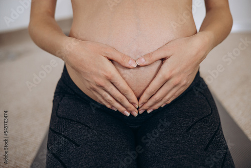 Wallpaper Mural Pregnant woman hugging her belly with hands Torontodigital.ca