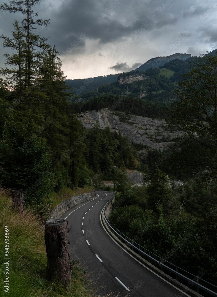 Vertical shot of Susten Pass surrounded by beautiful mountain scenery in Switzerland Vertical shot of Susten Pass surrounded by beautiful mountain scenery in Switzerland