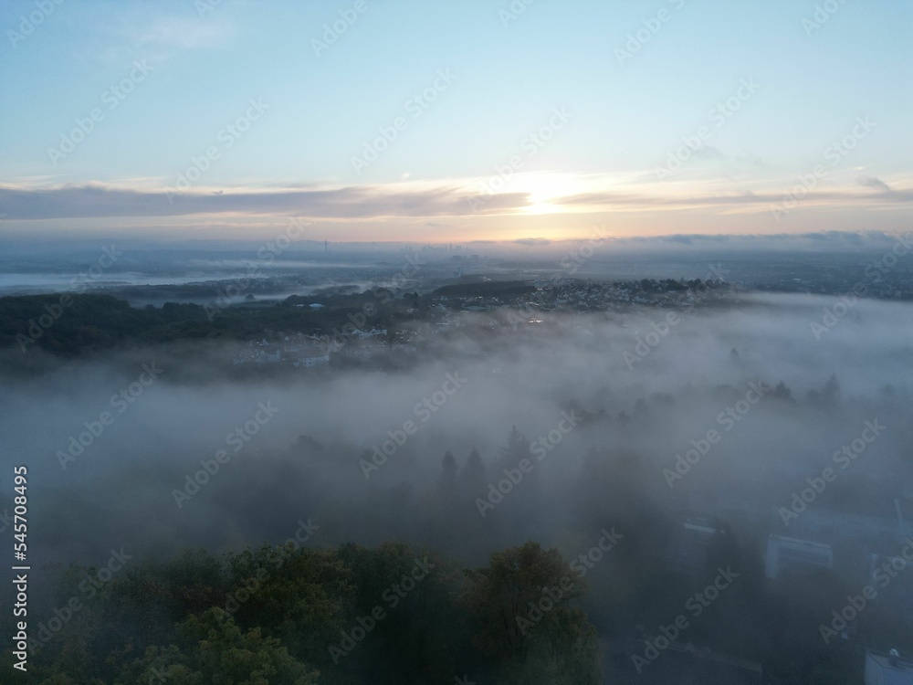 Aerial shot of clouds over the countryside at sunset