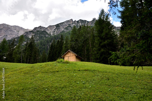 Small barn in a meadow under the mountains