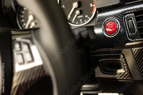 Red engine start button detail. Car dashboard with focus on red engine start stop button © Filippo Carlot