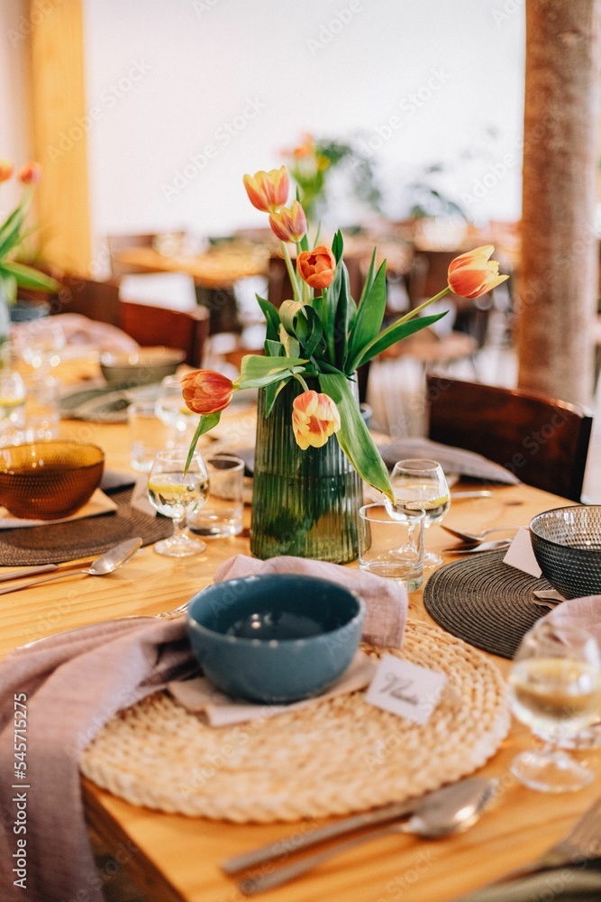 Vertical shot of a decorated wedding table with tulip flowers