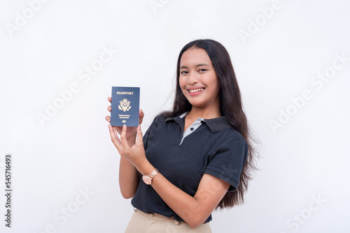 A happy asian woman proudly presents her newly acquired US passport. Isolated on a white background.