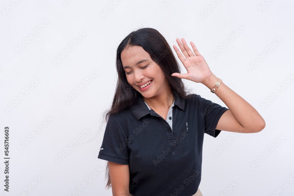 A happy young asian woman hears good and satisfying news. Gesturing with her hands on her ears. Isolated on a white background. A happy young asian woman hears good and satisfying news. Gesturing with her hands on her ears. Isolated on a white background.