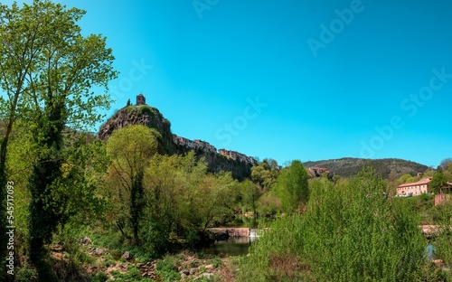 Panoramic view Castellfollit de la roca Village in spain with nature and river on the foreground photo