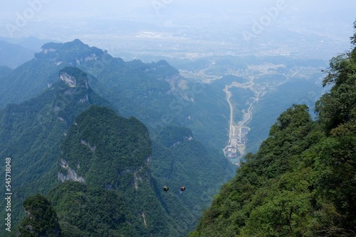 Aerial of cable cars going over the green Tianmen Mountain in Zhangjiajie, China