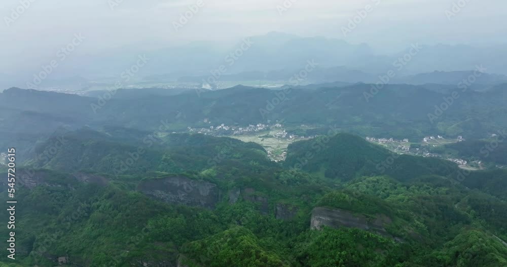 The villages in the distance loomed, Around Danxia Landform, in Cloudy Day The villages in the distance loomed, Around Danxia Landform, in Cloudy Day
