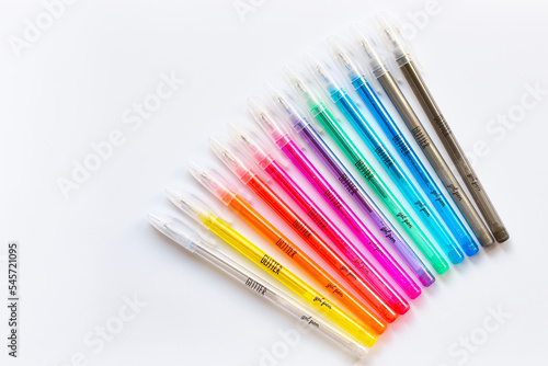 Glitter gel pens bright vivid colors on white paper background © The World Traveller