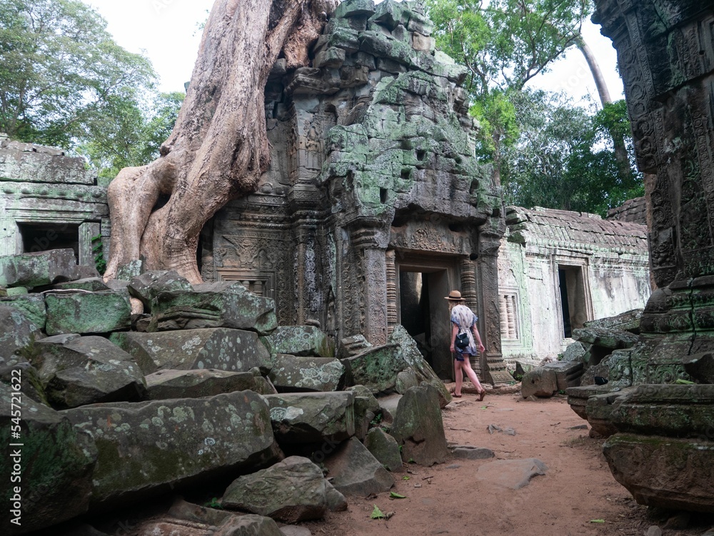 Woman with blonde hair and a dress exploring old historical ruins in daylight