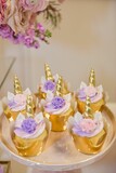 Closeup of the pink and purple unicorn cupcakes, a vertical shot