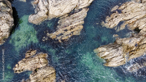 A lot of boulders in the sea water. Coastal cliffs of the North Atlantic. Seaside beautiful nature. Dramatic seascape of the north of Europe. Drone point of view.