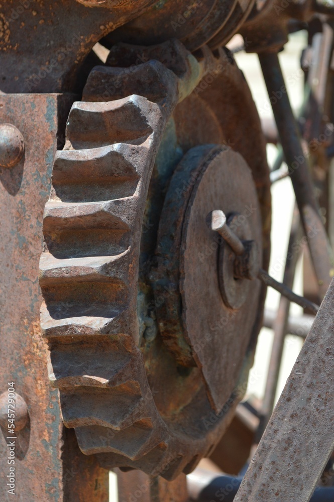 Vertical shot of a rusted gear on old farm equipment Vertical shot of a rusted gear on old farm equipment