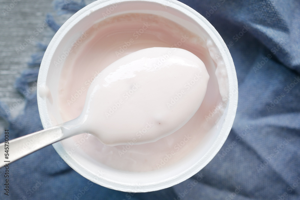 spoon pick fresh yogurt in a bowl on table spoon pick fresh yogurt in a bowl on table