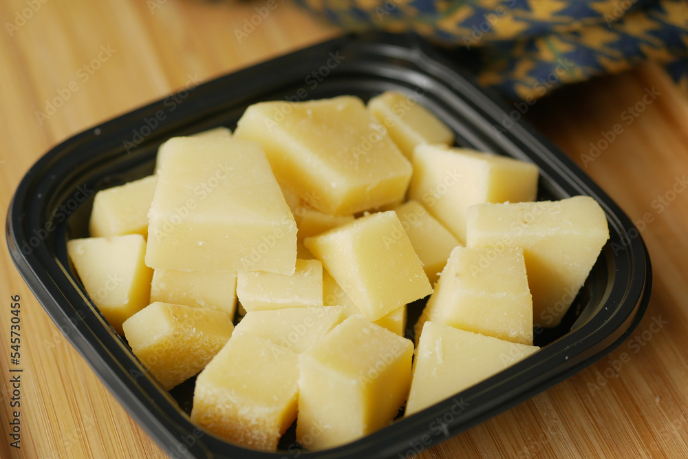 close up of cube shape fresh cheese on in a bowl close up of cube shape fresh cheese on in a bowl