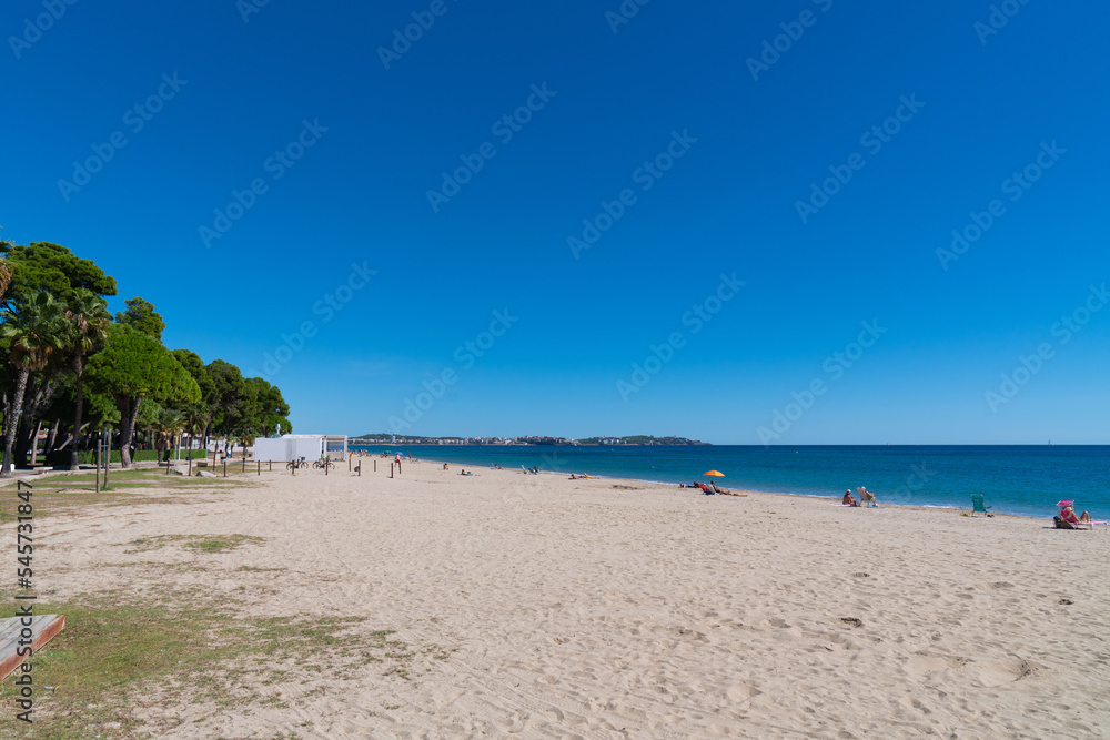 Platja Esquirol sandy beach Cambrils Spain with view to Salou Catalonia and blue Mediterranean sea
