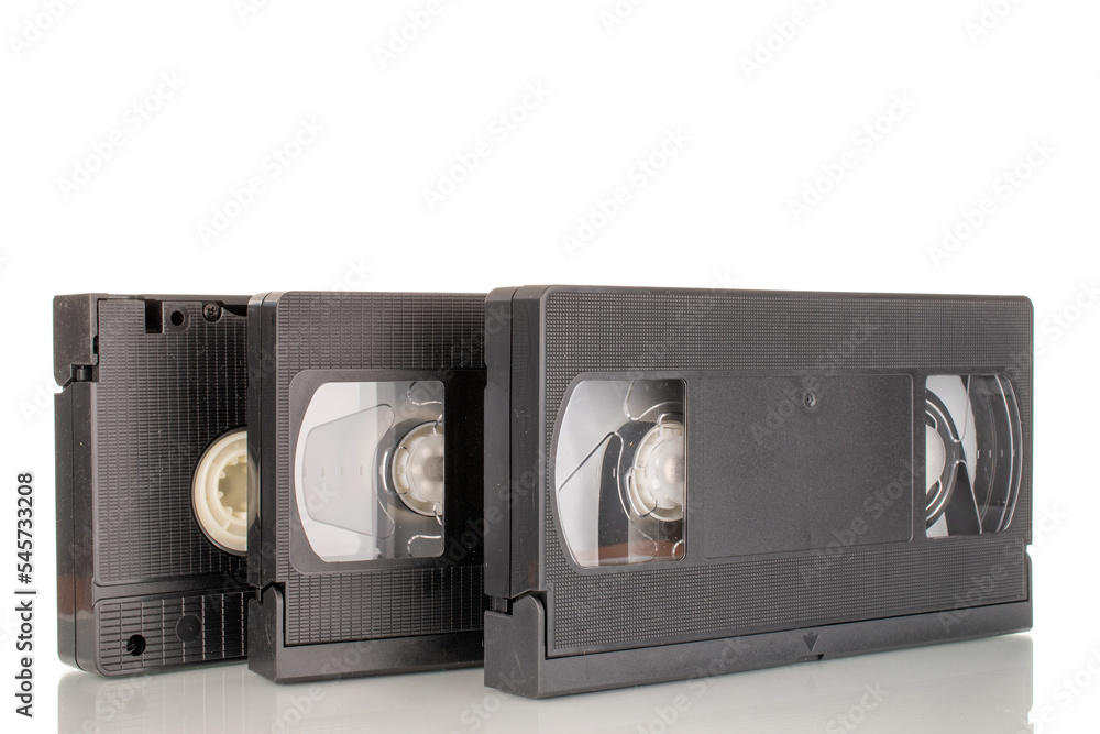 Three video cassettes, macro, isolated on white background.
