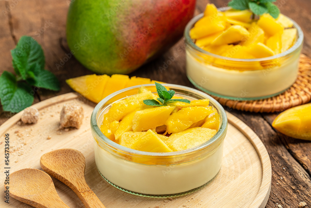 Mango desserts. panna cotta with pieces of fresh mango. Italian dessert. Food recipe background. Close up