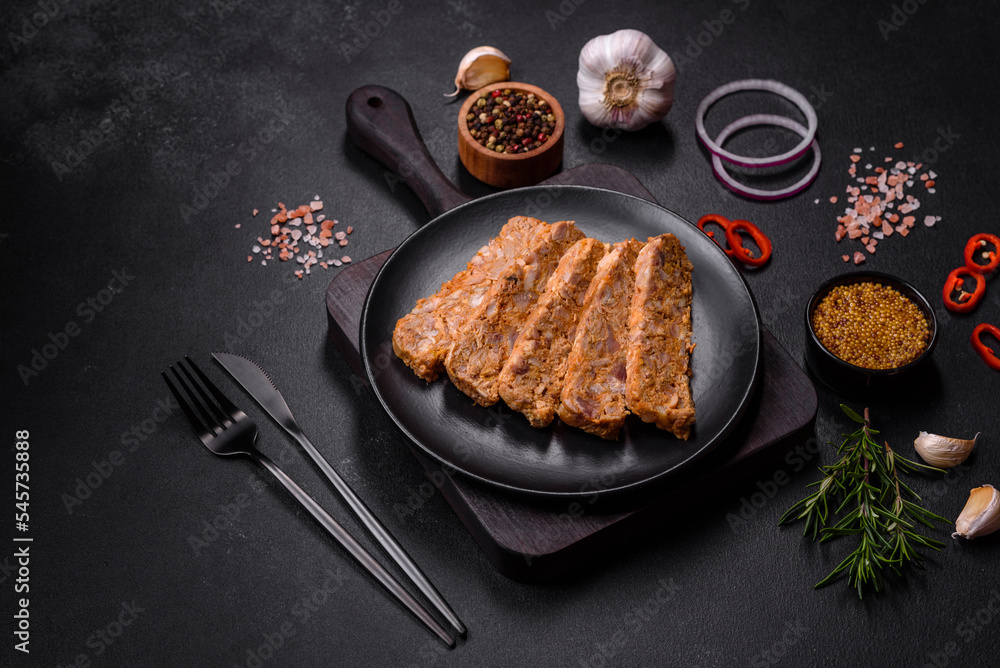 Tasty meat brawn or roll on a wooden cutting board with spices and herbs Tasty meat brawn or roll on a wooden cutting board with spices and herbs