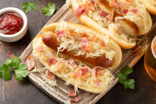 Roasted Beer Bratwurst sausage with sauerkraut and bacon on wooden board